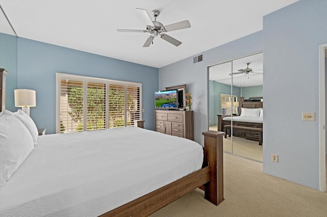 bedroom featuring ceiling fan, a closet, and light colored carpet