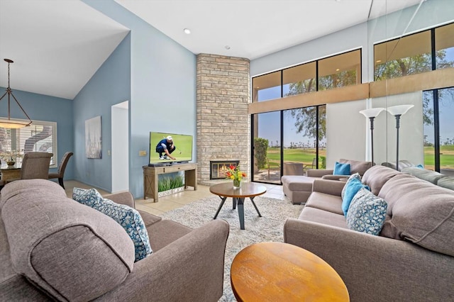 living room with high vaulted ceiling, light tile patterned floors, and a stone fireplace