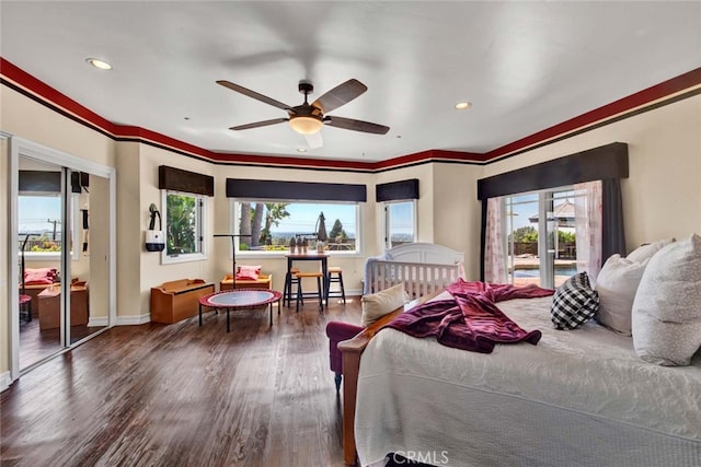 bedroom with ornamental molding, dark hardwood / wood-style flooring, and ceiling fan