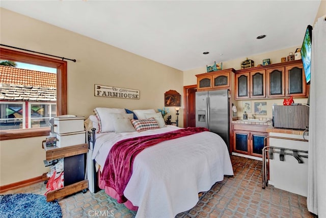 bedroom featuring stainless steel refrigerator with ice dispenser and sink