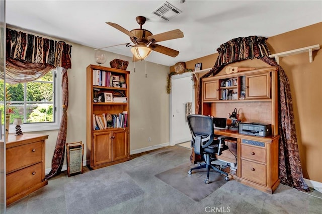 carpeted office featuring ceiling fan