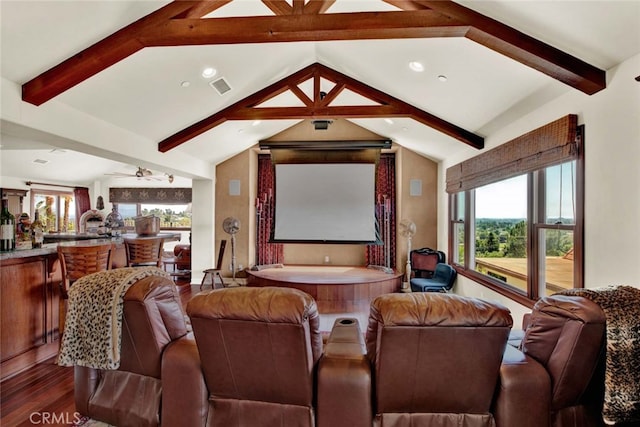 home theater with wood-type flooring, lofted ceiling with beams, and ceiling fan