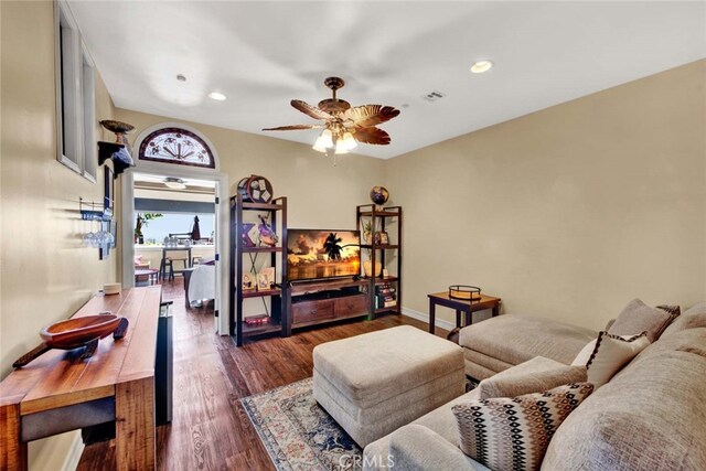 living room with ceiling fan and dark hardwood / wood-style floors