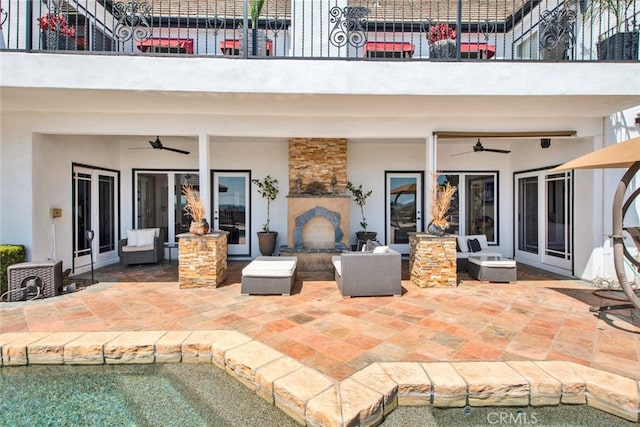 view of patio featuring an outdoor living space, ceiling fan, and french doors