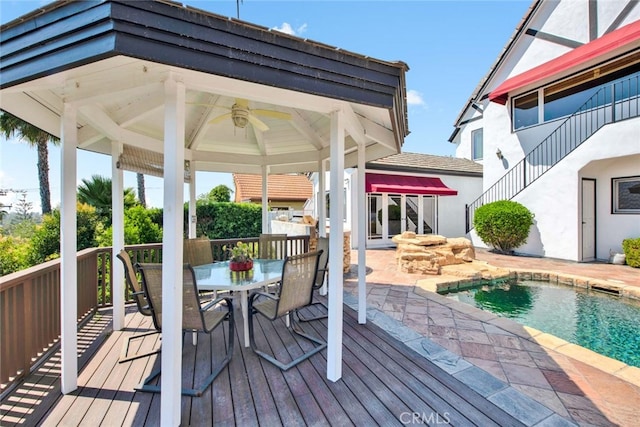 wooden terrace with ceiling fan and a gazebo