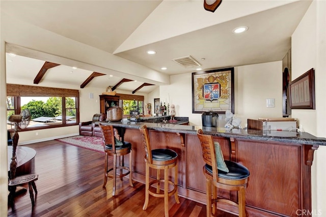 bar with vaulted ceiling with beams and dark hardwood / wood-style floors