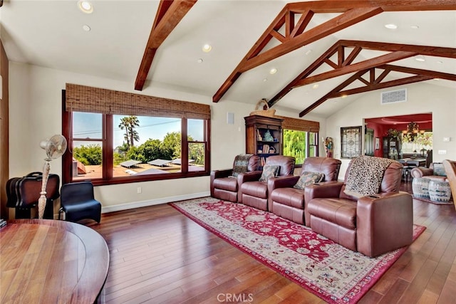 living room with a notable chandelier, beamed ceiling, dark hardwood / wood-style flooring, and a healthy amount of sunlight