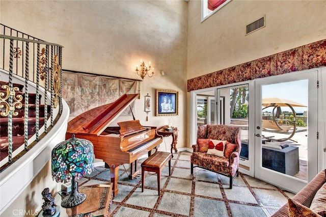 sitting room featuring french doors and a high ceiling