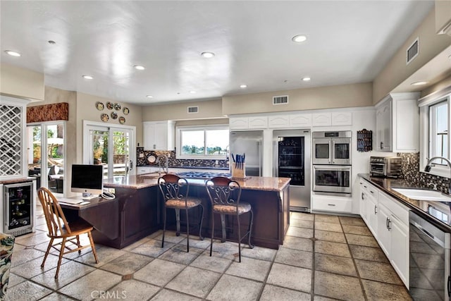 kitchen featuring white cabinets, sink, and a healthy amount of sunlight