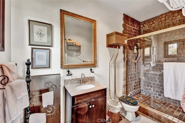 bathroom with vanity, toilet, and an enclosed shower