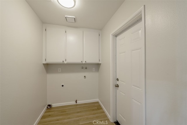 laundry room featuring light hardwood / wood-style floors, cabinets, electric dryer hookup, and hookup for a gas dryer