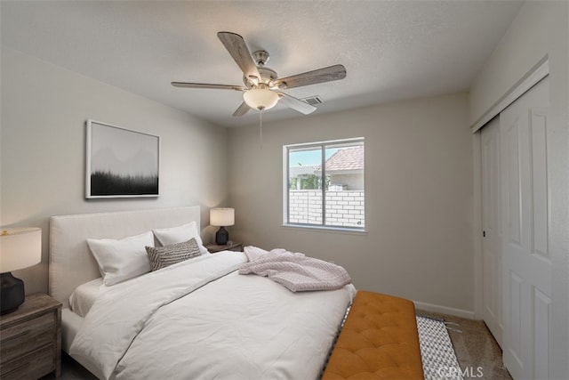 carpeted bedroom with a closet and ceiling fan