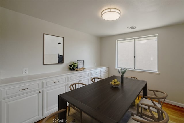 dining space with light hardwood / wood-style flooring