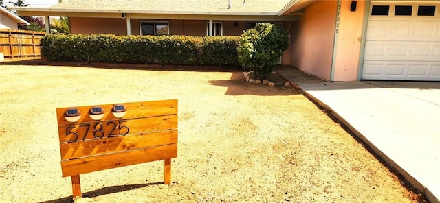 view of yard with a garage and fence