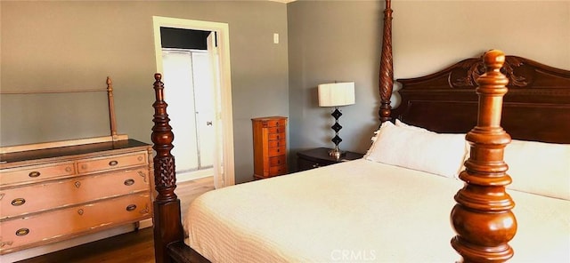 bedroom with dark wood-type flooring