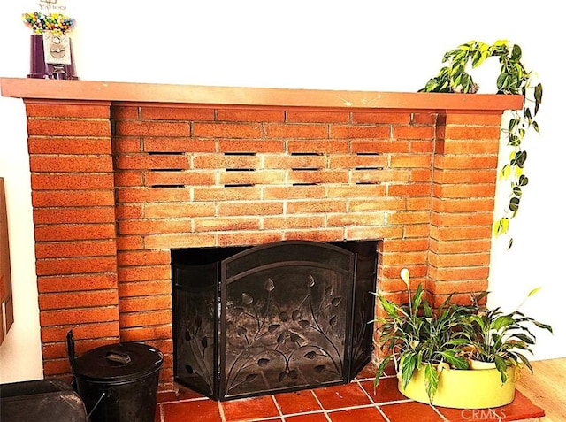 interior details featuring hardwood / wood-style flooring and a fireplace