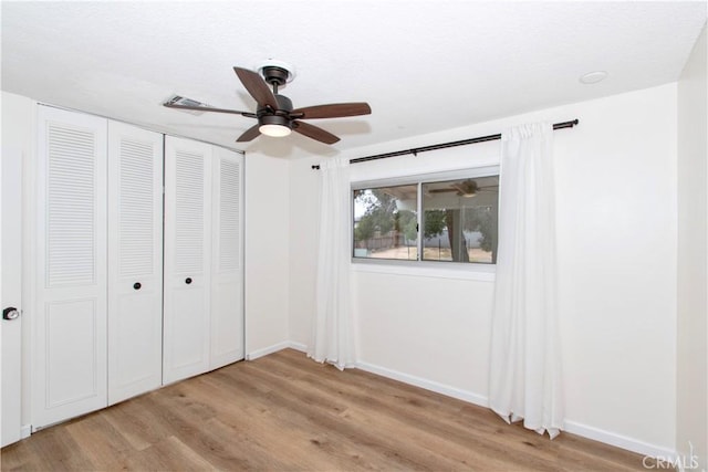 57825 El Dorado Dr, Yucca Valley, CA 92284 - unfurnished bedroom featuring wood finished floors, a closet, and a ceiling fan