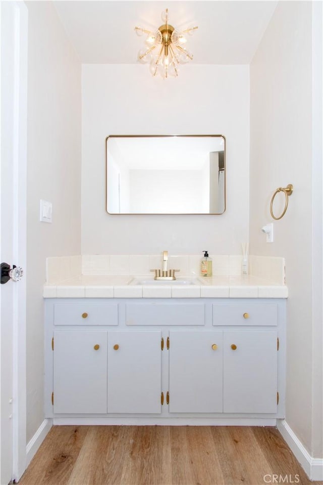 57825 El Dorado Dr, Yucca Valley, CA 92284 - bathroom featuring vanity, wood finished floors, and a chandelier