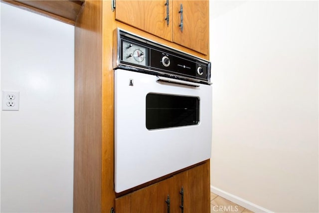 57825 El Dorado Dr, Yucca Valley, CA 92284 - kitchen view of oven and brown cabinets