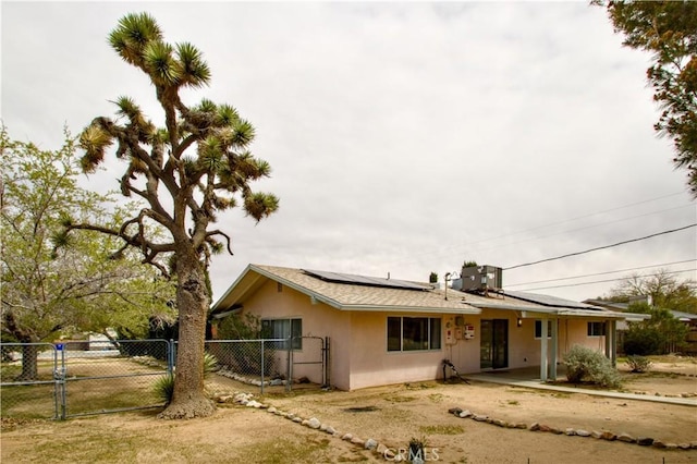 57825 El Dorado Dr, Yucca Valley, CA 92284 - ranch-style house featuring a gate, solar panels, and stucco siding