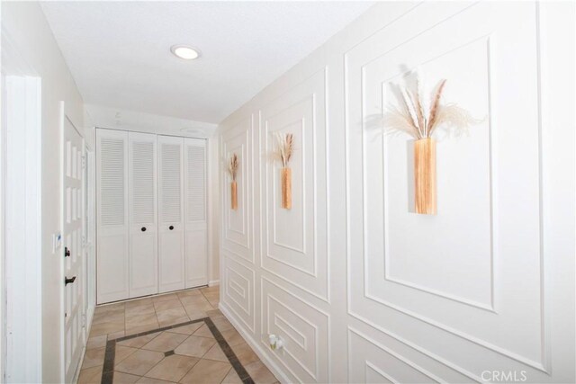 57825 El Dorado Dr, Yucca Valley, CA 92284 - hallway featuring inlaid floor details, light tile patterned flooring, and recessed lighting