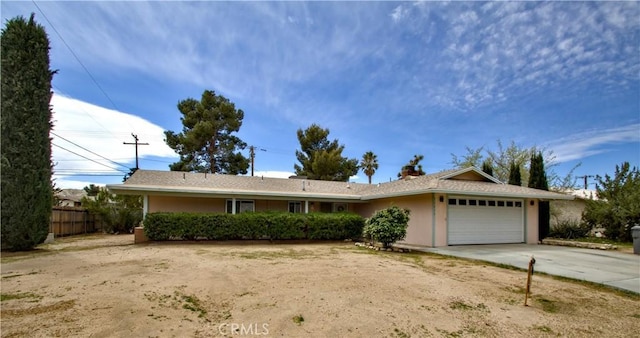 57825 El Dorado Dr, Yucca Valley, CA 92284 - single story home with an attached garage, driveway, stucco siding, and a chimney