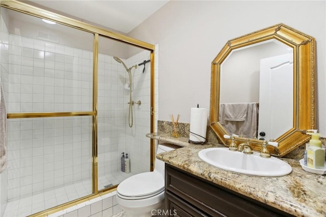 bathroom featuring vanity, toilet, and walk in shower