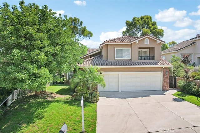 mediterranean / spanish-style house with a garage and a front yard