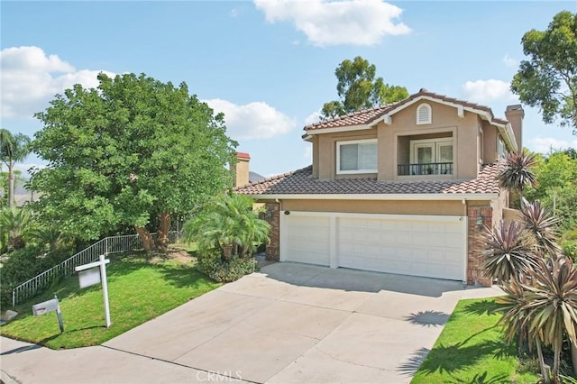 mediterranean / spanish-style house with a garage and a front lawn