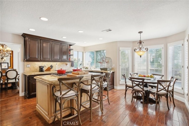 kitchen with a center island, plenty of natural light, and dark hardwood / wood-style floors