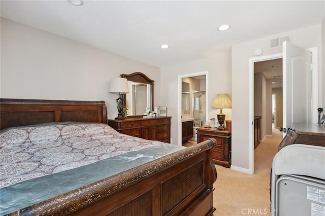 bedroom featuring ensuite bathroom and light carpet