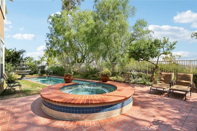 view of patio / terrace featuring a pool with hot tub