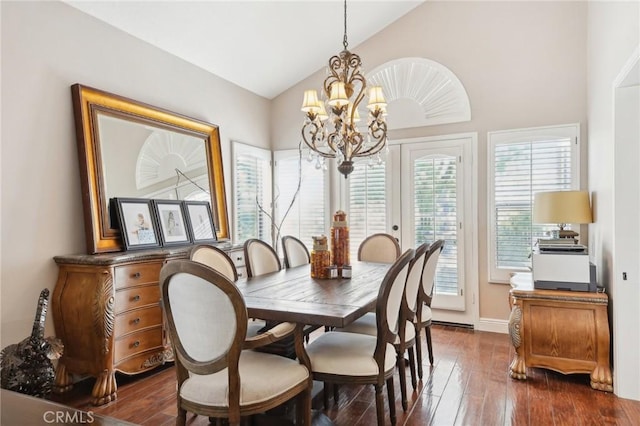 dining space with a chandelier, high vaulted ceiling, and dark wood-type flooring