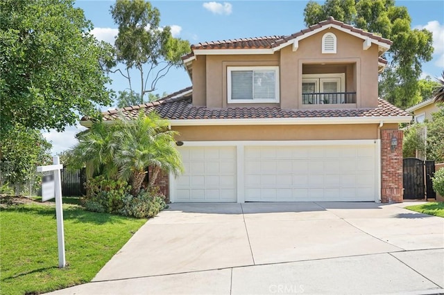 mediterranean / spanish home featuring a front yard and a garage