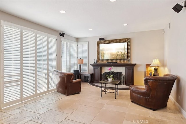 sitting room with a tile fireplace