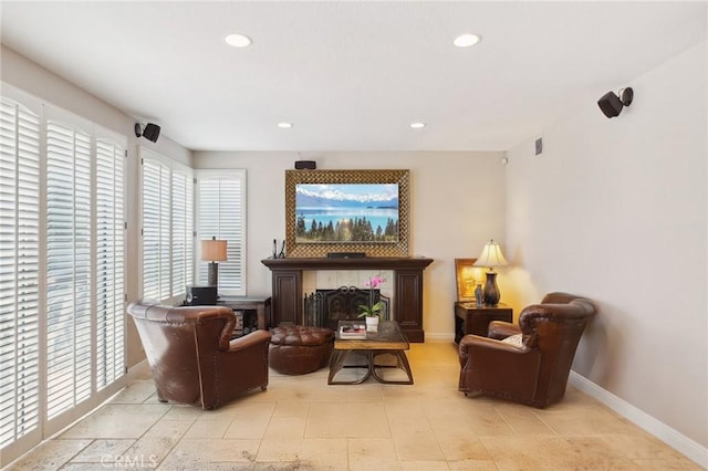 living area with a tile fireplace