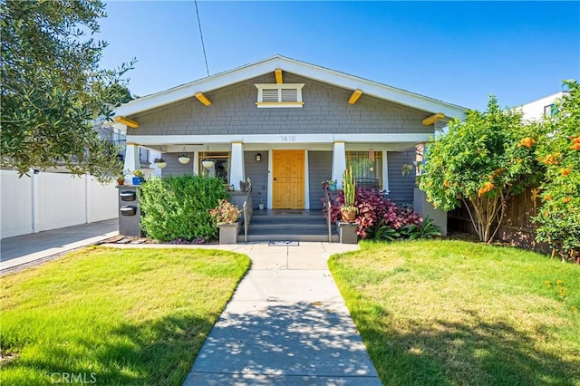 bungalow featuring a porch and a front yard