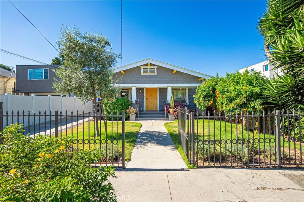 bungalow-style home featuring a porch and a front lawn