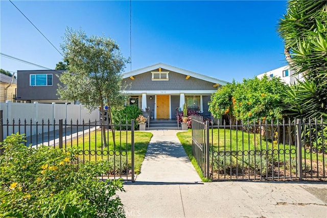 bungalow-style home featuring a porch and a front lawn