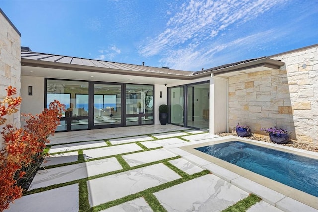 67 Monarch Bay Dr, Dana Point, CA 92629 - back of house featuring stone siding, stucco siding, and a patio