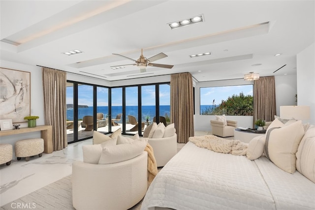 bedroom featuring a water view, ceiling fan, and access to exterior