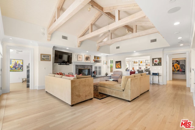 living room featuring light hardwood / wood-style floors, beam ceiling, and high vaulted ceiling