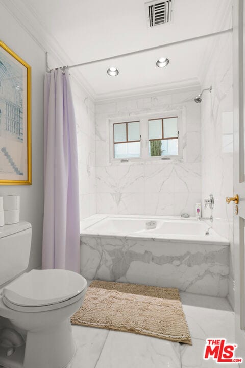 bathroom featuring shower / bath combo with shower curtain, crown molding, and toilet