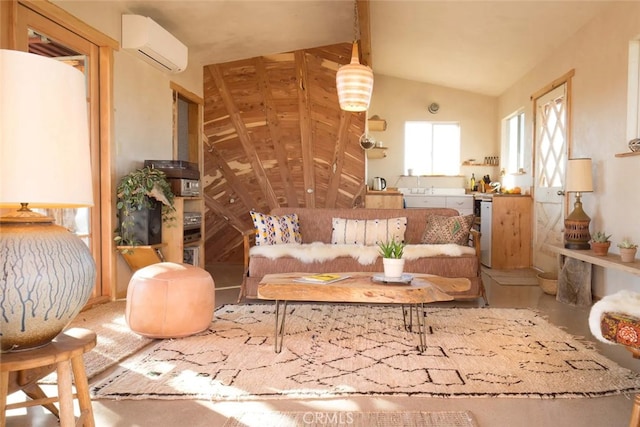 sitting room featuring lofted ceiling and an AC wall unit