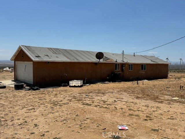 back of property featuring a garage