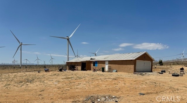 exterior space featuring an outdoor structure and a rural view