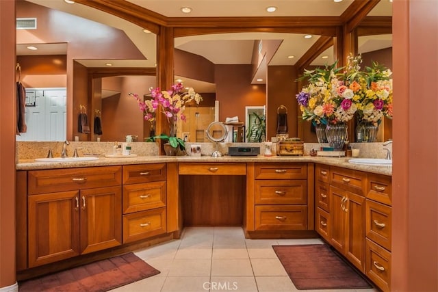 bathroom featuring tile patterned flooring, vaulted ceiling, and vanity