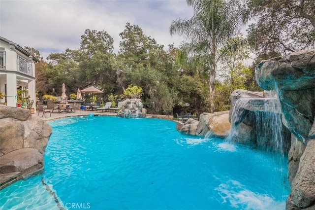 view of pool featuring a patio area and pool water feature