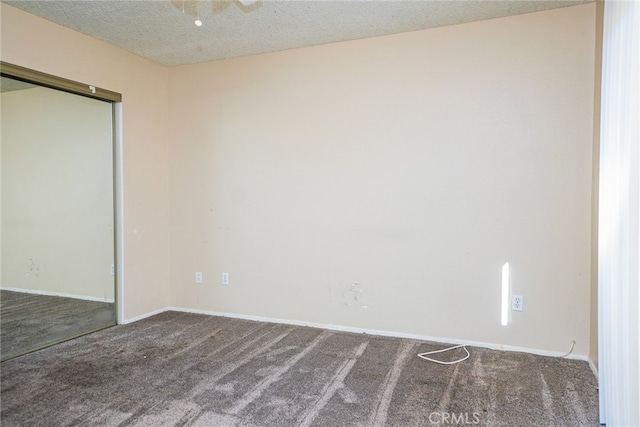 unfurnished bedroom featuring a textured ceiling and carpet flooring