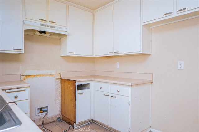 kitchen featuring white cabinetry and light tile patterned floors